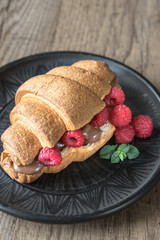 Croissant with chocolate paste and fresh raspberries