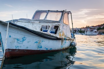 Fototapeta premium Dirty old boat in marina in a Mediterranean village