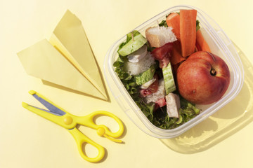 lunch of child in plastic boxes on yellow background. Healthy food for child. Top view, flat lay