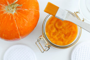 Homemade pumpkin face mask in a glass jar. DIY cosmetics and spa. Copy space.