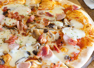 Homemade pizza on wood close up