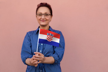 Croatia flag. Woman holding Croatian flag. Nice portrait of middle aged lady 40 50 years old with a...