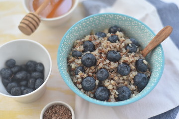 Buckwheat porridge in a bowl with flax seeds and blueberries. oncept healthy food, detox, diet, breakfast