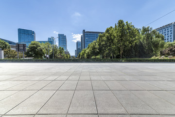 Fototapeta premium Panoramic skyline and modern business office buildings with empty road,empty concrete square floor
