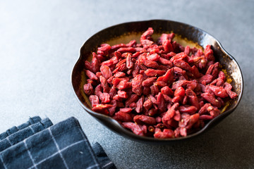 Organic Dried Goji Berries in Ceramic Bowl.