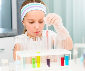 little girl with flasks for chemistry