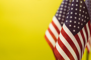 Flags United States of America with yellow background empty space for your text on left.