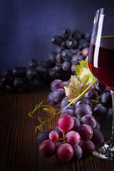 Glass with red wine and grapes