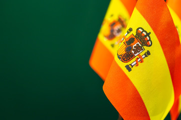 Flags of Spain with green background empty space for your text on left.
