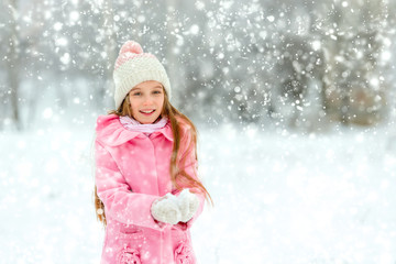 Girl playing with snow on holidays