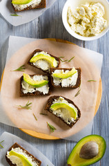 sandwich bread rye cheese curd avocado dill  wooden  background

