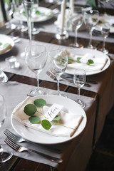 Table card with the name of the guest on the plate. A beautiful wooden table for any festive occasion, party or wedding.