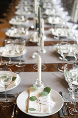 Table card with the name of the guest on the plate. A beautiful wooden table for any festive occasion, party or wedding.