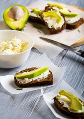 sandwich bread rye cheese curd avocado dill  wooden  background
