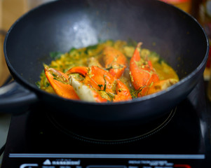 Crab in curry fried in pan in kitchen