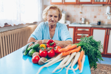 Happy senior woman with fresh crop from her garden