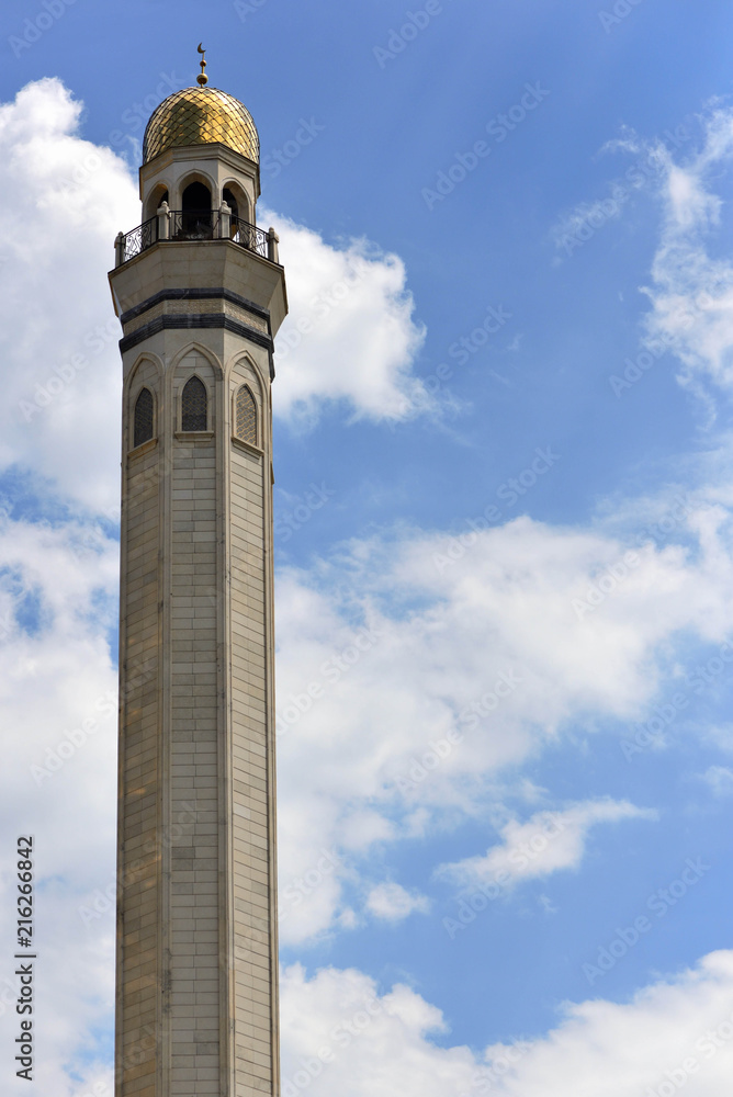 Wall mural minaret tall tower an a blue sky