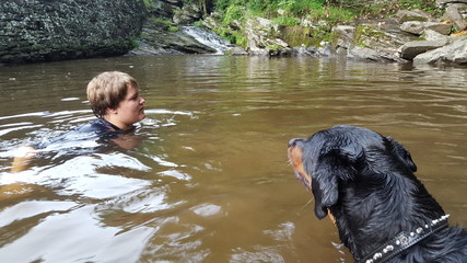 Boy Swimming With His Dog, Zeus The Rottweiler In A Pennsylvania Creek