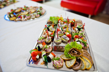 Close-up photo of salty snacks made with meat on the table.