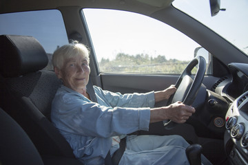 an elderly woman driving