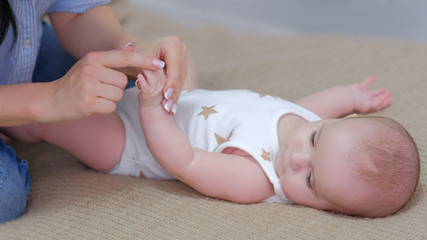 healthy baby development. mom doing exercises with her newborn. child fitness.