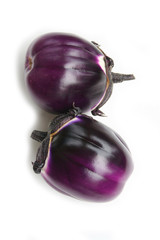 Raw round purple eggplants isolated on white background. Summer vegetables