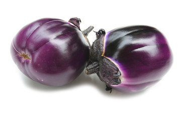 Raw round purple eggplants isolated on white background. Summer vegetables