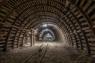 Tunnel in the mine, track, light in the end