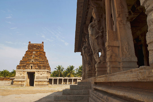 Carved Pillars of Kalyana Mandapa, Divine Marriage Hall, and Gopuram on the East. Pattabhirama Temple, Hampi, Karnataka. View from west.