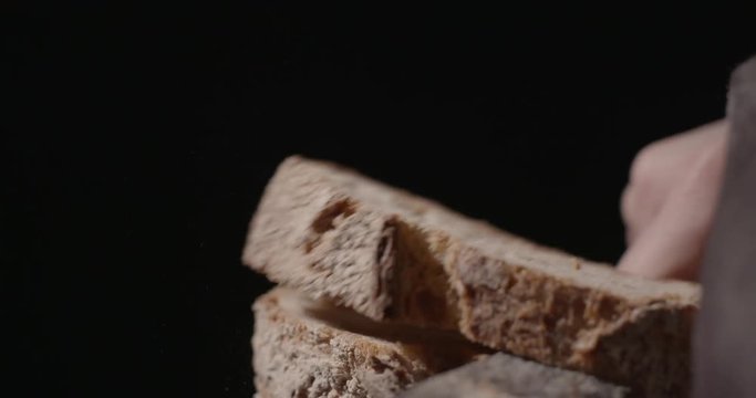 Slicing artisanal bread  contrast black background
