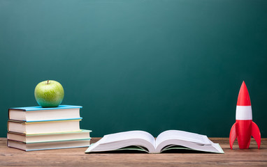 Fresh Apple, Books And Rocket On Desk