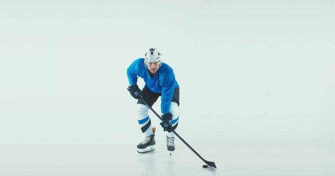 FIXED Portrait of Caucasian male ice hockey player in uniform posing against white background. Studio shot. 4K UHD 60 FPS SLOW MOTION