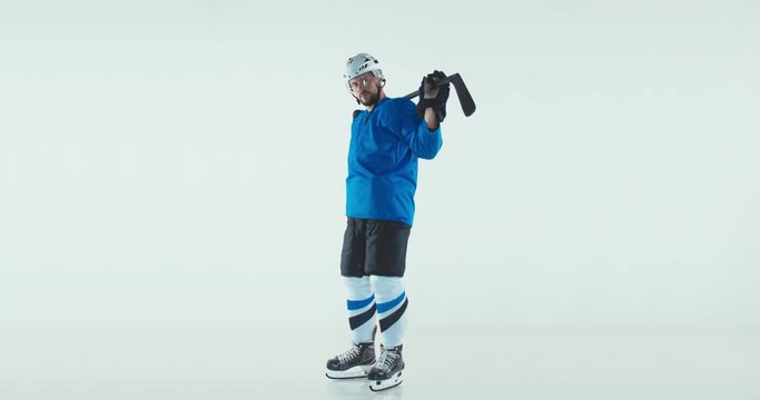 FIXED Portrait of Caucasian male ice hockey player in uniform posing against white background. Studio shot. 4K UHD 60 FPS SLOW MOTION