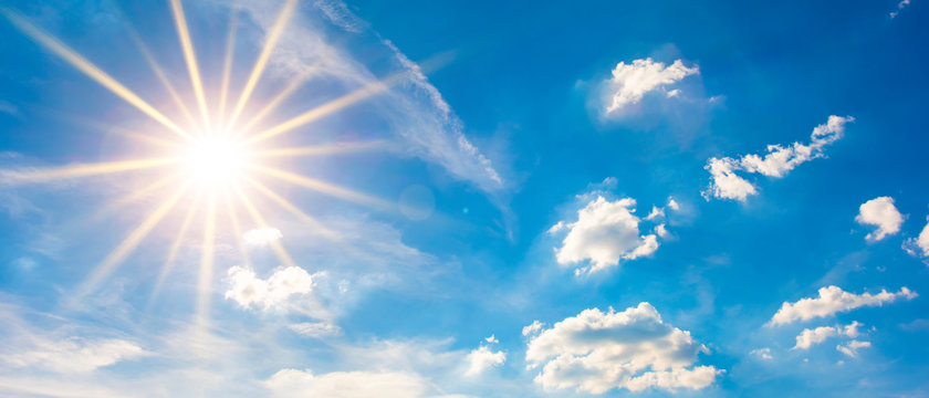 Hot summer or heat wave background, blue sky with glowing sun