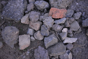 Large cobblestones broken stones and a baby for construction and repair work