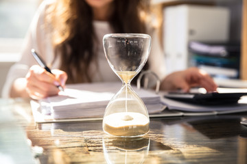 Close-up Of A Hourglass On Desk