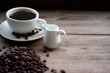 coffee  cup and coffee bean on old wood table