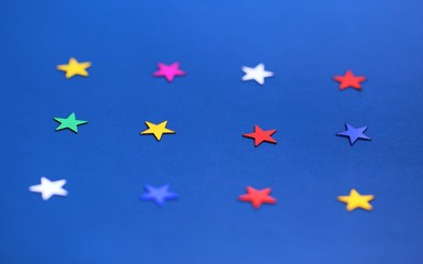 Flat lay of star decorations closeup on blue texture blur background