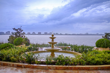 Fountain at sunset with the backdrop of a salt lake and a city in the distance 1