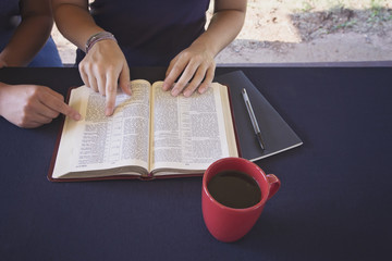 A Friend Helping Someone Study the Bible