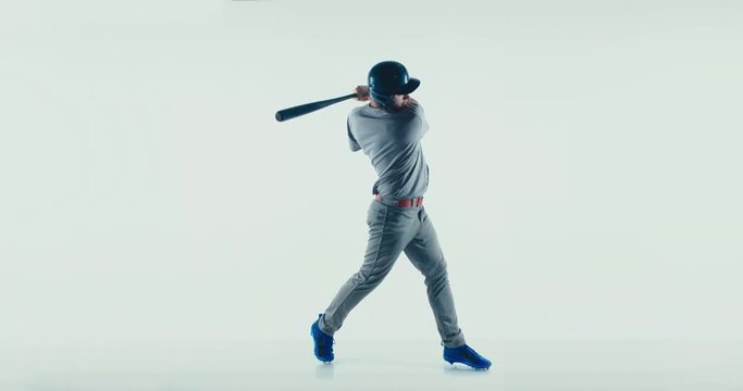 Caucasian professional baseball player batter wearing generic uniform posing as if he was hitting a ball isolated on white background. 4K UHD 60 FPS SLOW MOTION