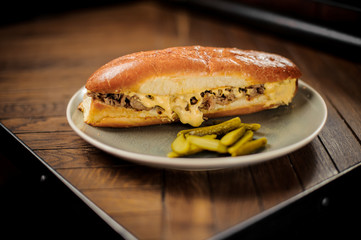 Sandwich with meat and cheese sause with cucumbers