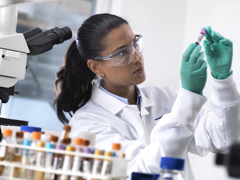 Female scientist preparing a blood sample for clinical testing in the laboratory