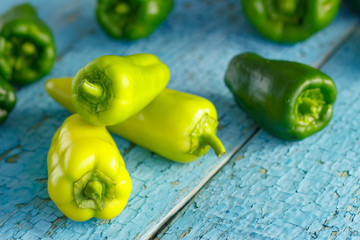 Green peppers on the blue wooden background