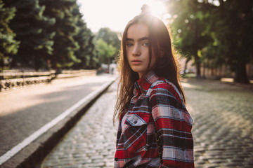 Teen girl wearing plaid shirt standing while walking