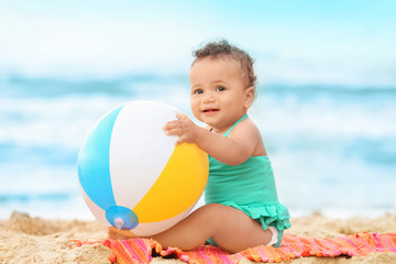 Adorable African-American girl playing on beach