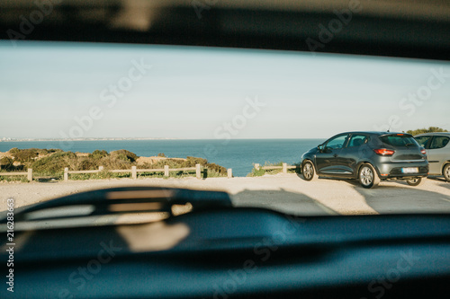 View Through The Rear Window Of The Car To The Parking Lot With