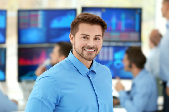 Happy male stock trader in office