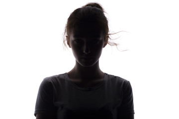 silhouette of a serious and confident young woman looking straigh on a white isolated background