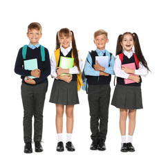 Little children in stylish school uniform on white background